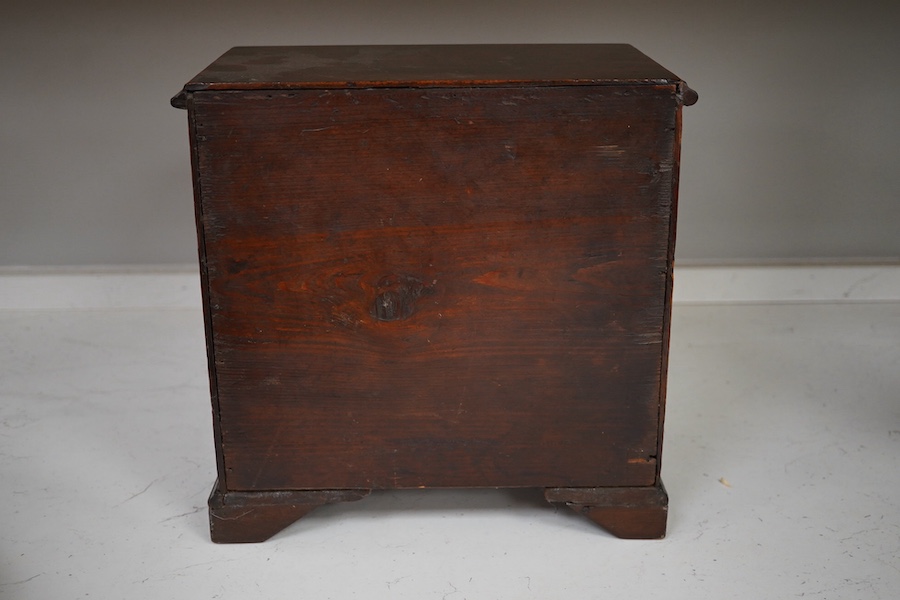 A 19th century miniature mahogany chest of five drawers, 28cm high. Condition - fair to good